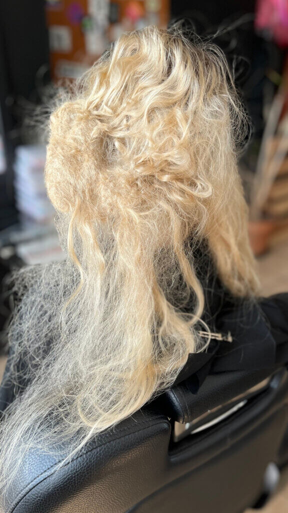 A mat in fair hair, viewed from beside the salon chair